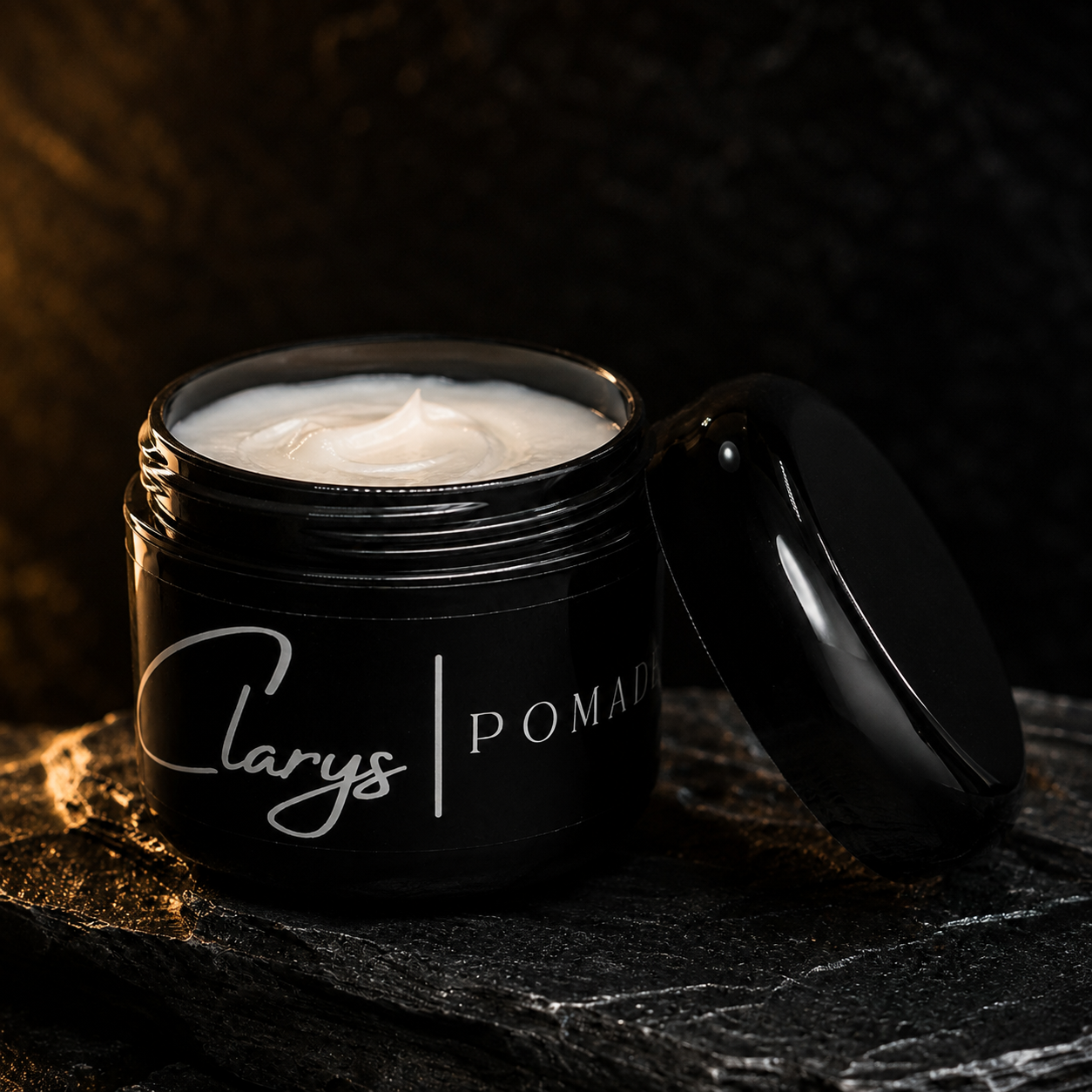 Open jar of Clary's Original Pomade showing the creamy water-based pomade texture