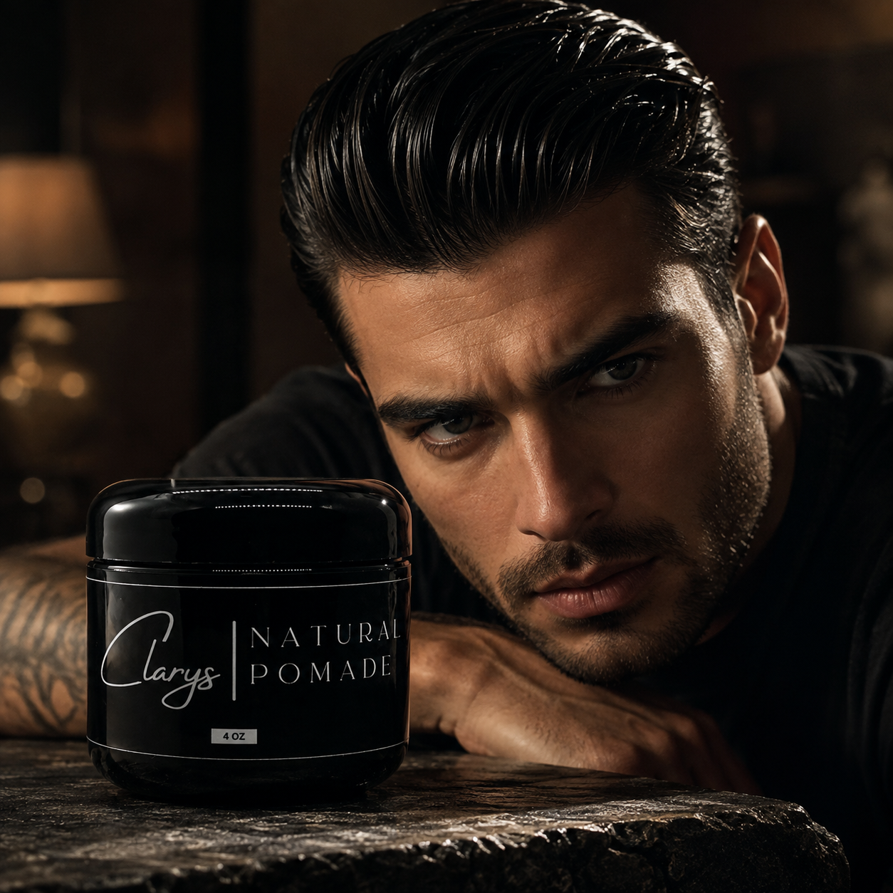 Man with a glossy slicked-back hairstyle beside a jar of Clary's All-Natural Pomade
