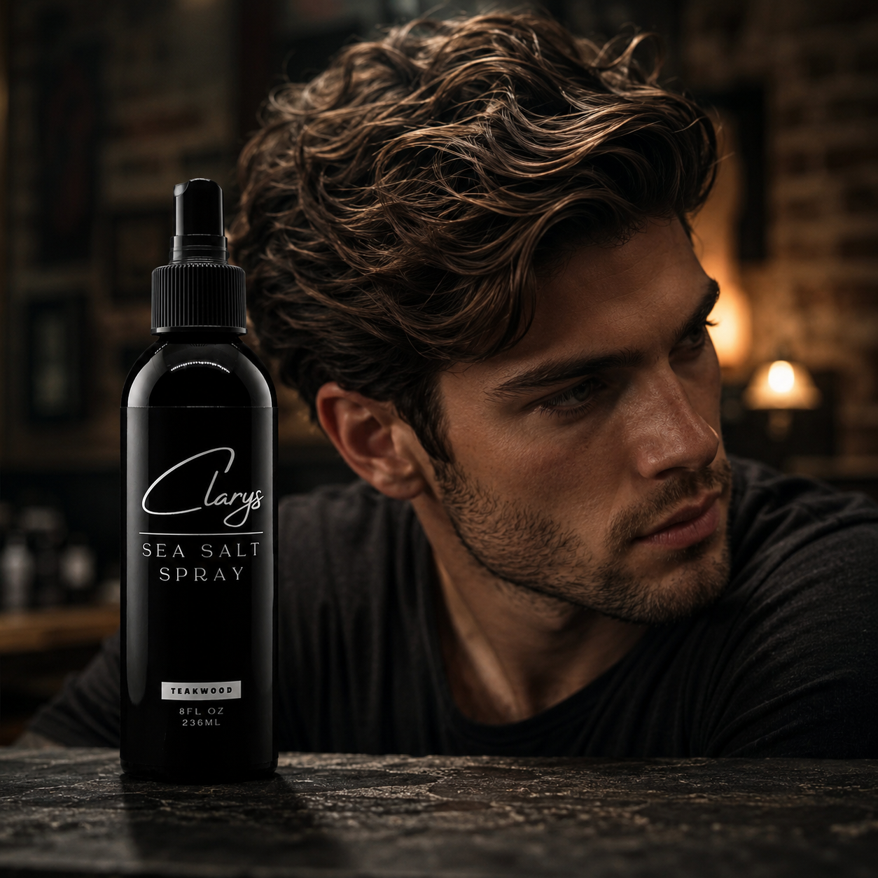Man with wavy, voluminous hair next to Clary's Signature Sea Salt Spray for men